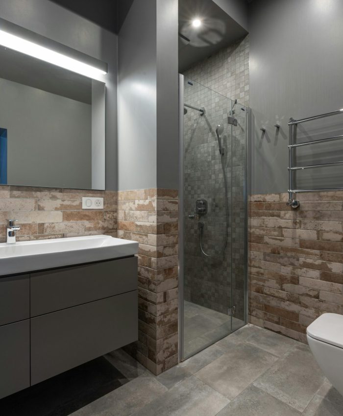 Sleek modern bathroom featuring a glass shower, floating vanity, and stylish decor.